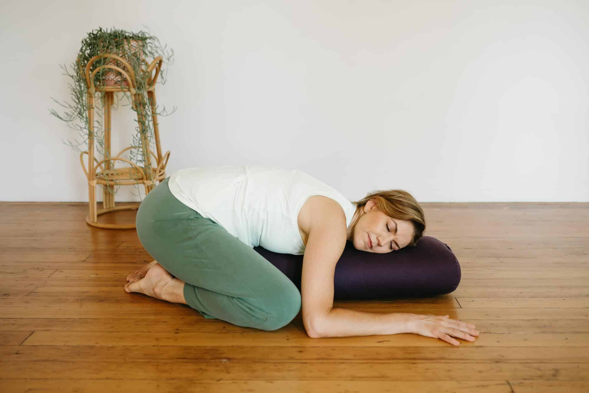 image of a person using a yoga bolster